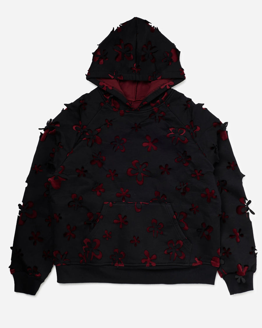 Black oversized hoodie with laser-cut flower motif and oxblood lining