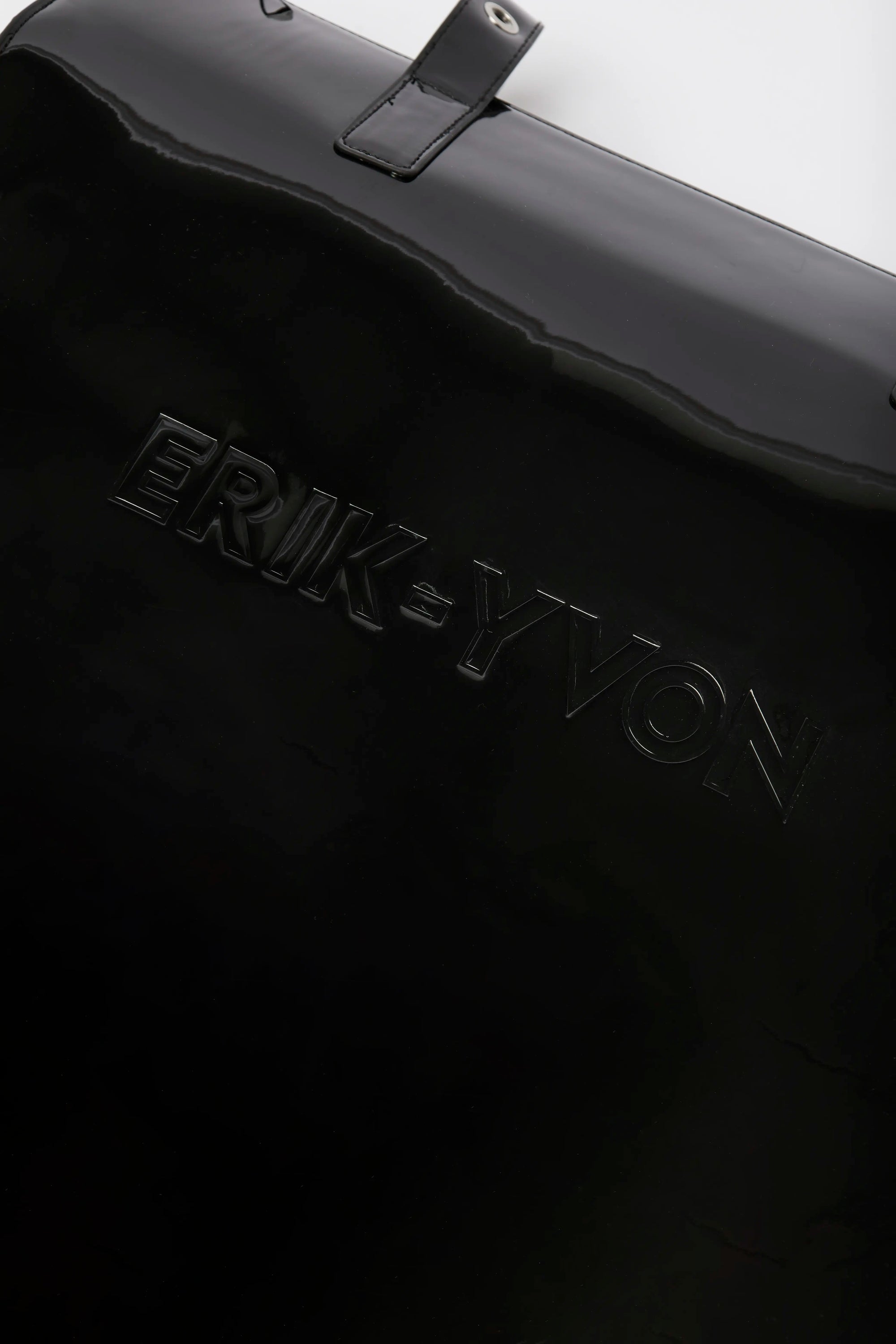 Close-up of a black bag with embossed ERIK-YVON wordmark.
