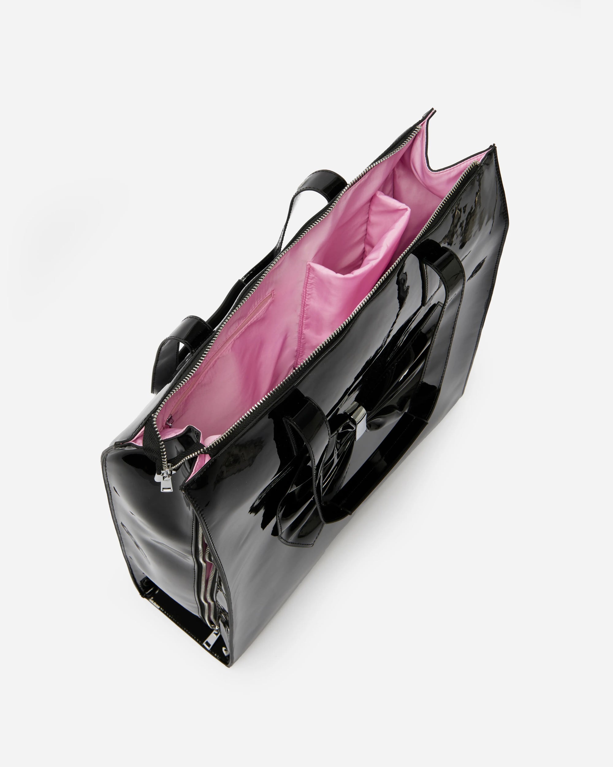 Black oversized tote bag with a pink interior, featuring a bow detail on the front and silver-tone hardware.